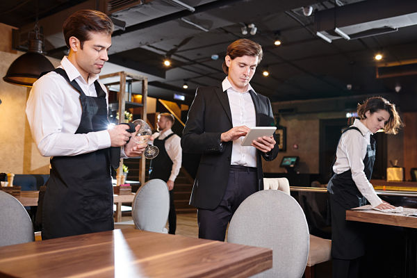 restaurant manager using tablet