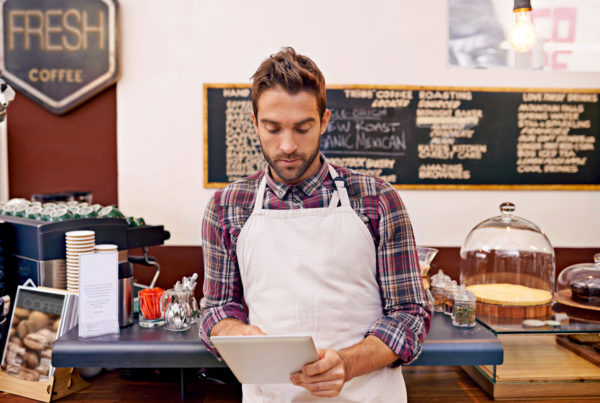 restaurant owner looking at trends in tablet