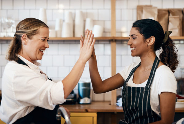 Multi unit restaurant employees giving each other a high five