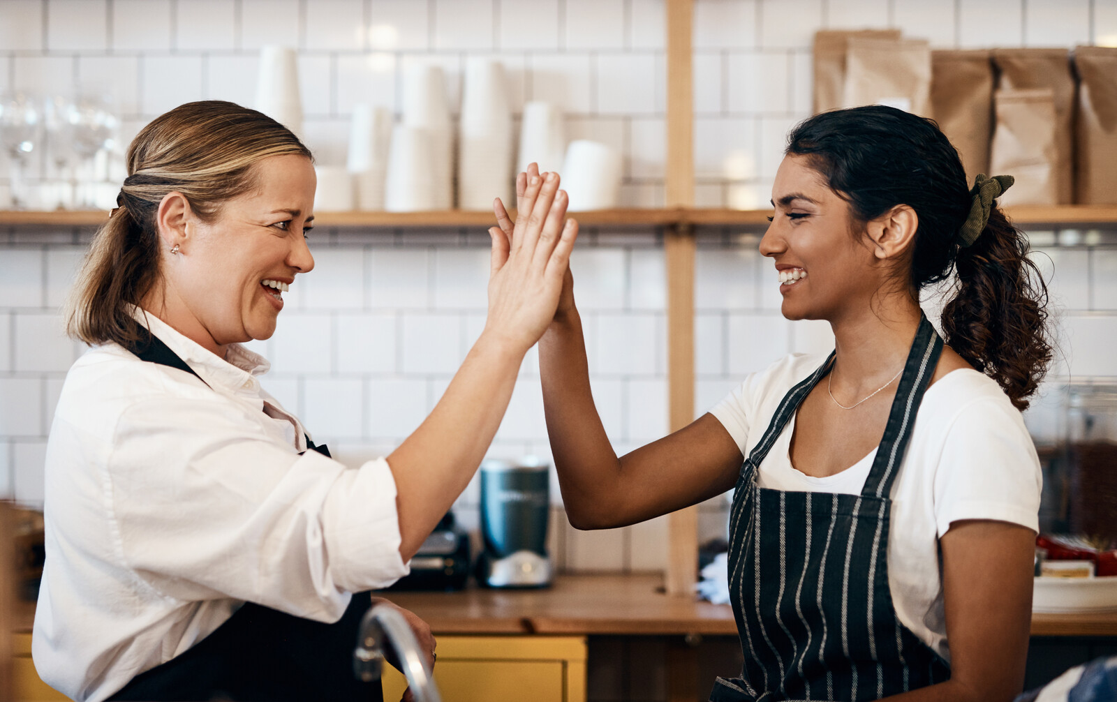 Multi unit restaurant employees giving each other a high five