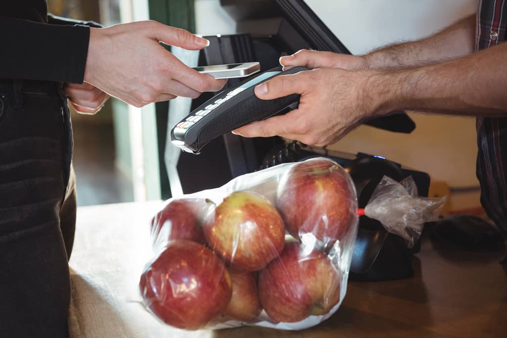 customer paying bill at store counter with latest scan technology