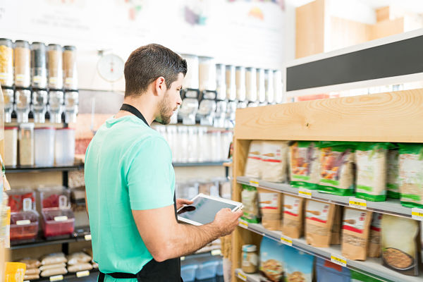 employee checking stock at c-store