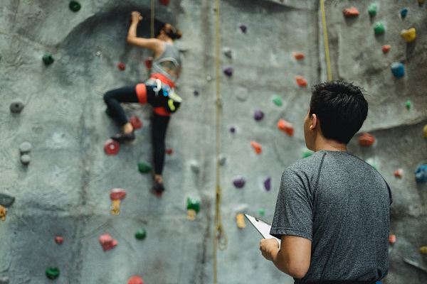 gym coach using clipboard