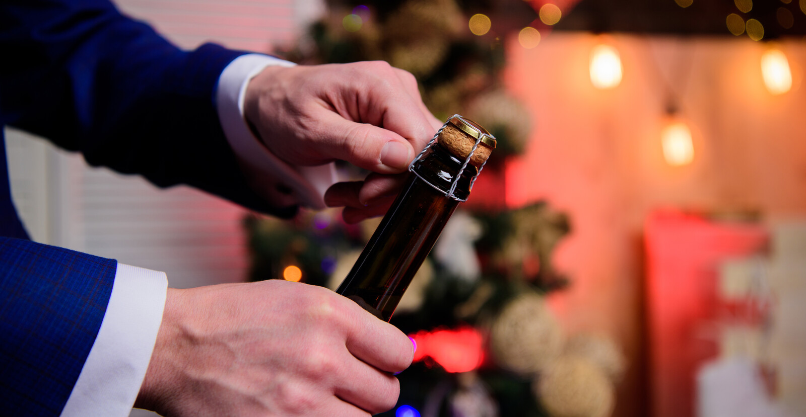 person popping champagne