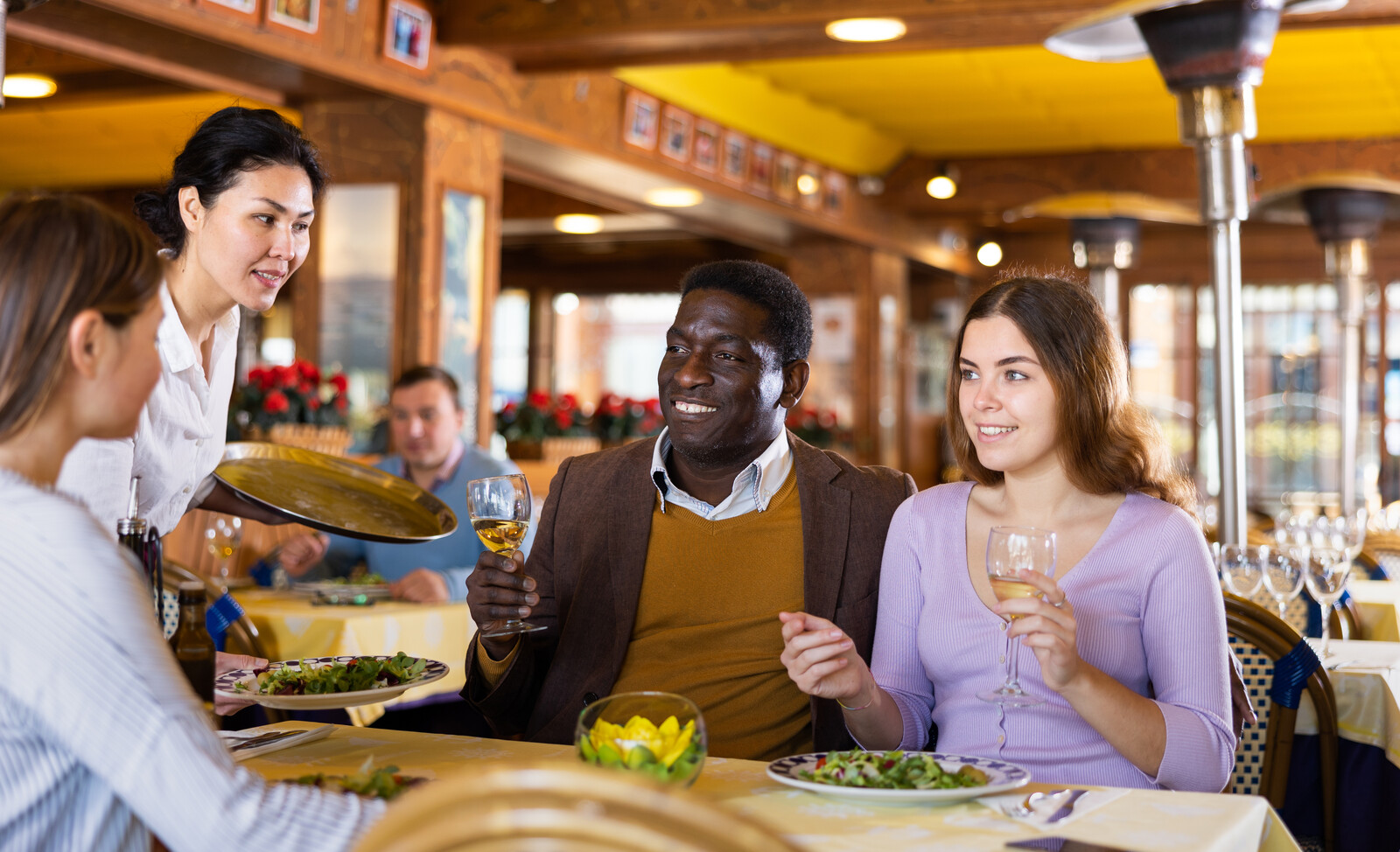 restaurant manager with customers