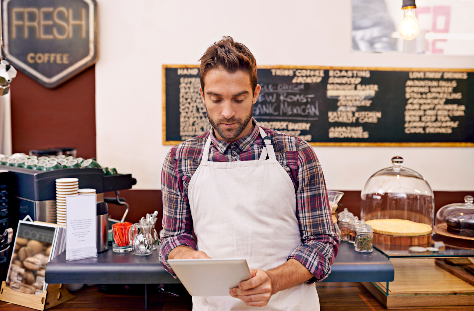 restaurant owner looking at trends in tablet