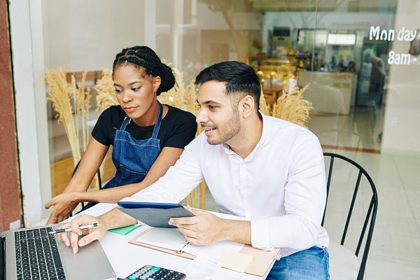restaurant worker and manager working on accounts